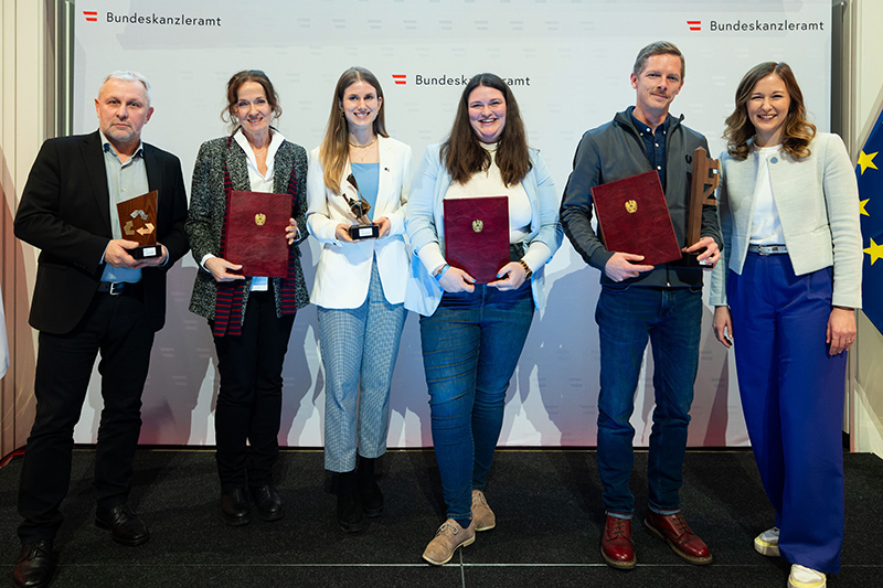 Preisträgerinnen und Preisträger auf der Bühne.
